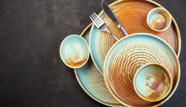 top-view-brown-plates-with-fork-knife-dark-surface_179666-34856